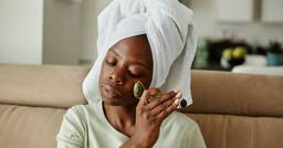 Early childhood educator sitting on the couch with a towel in her hair while resting at home
