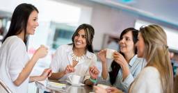 Group of four early childhood educators having a morning cup of coffee together
