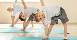 Preschool children practicing yoga indoors